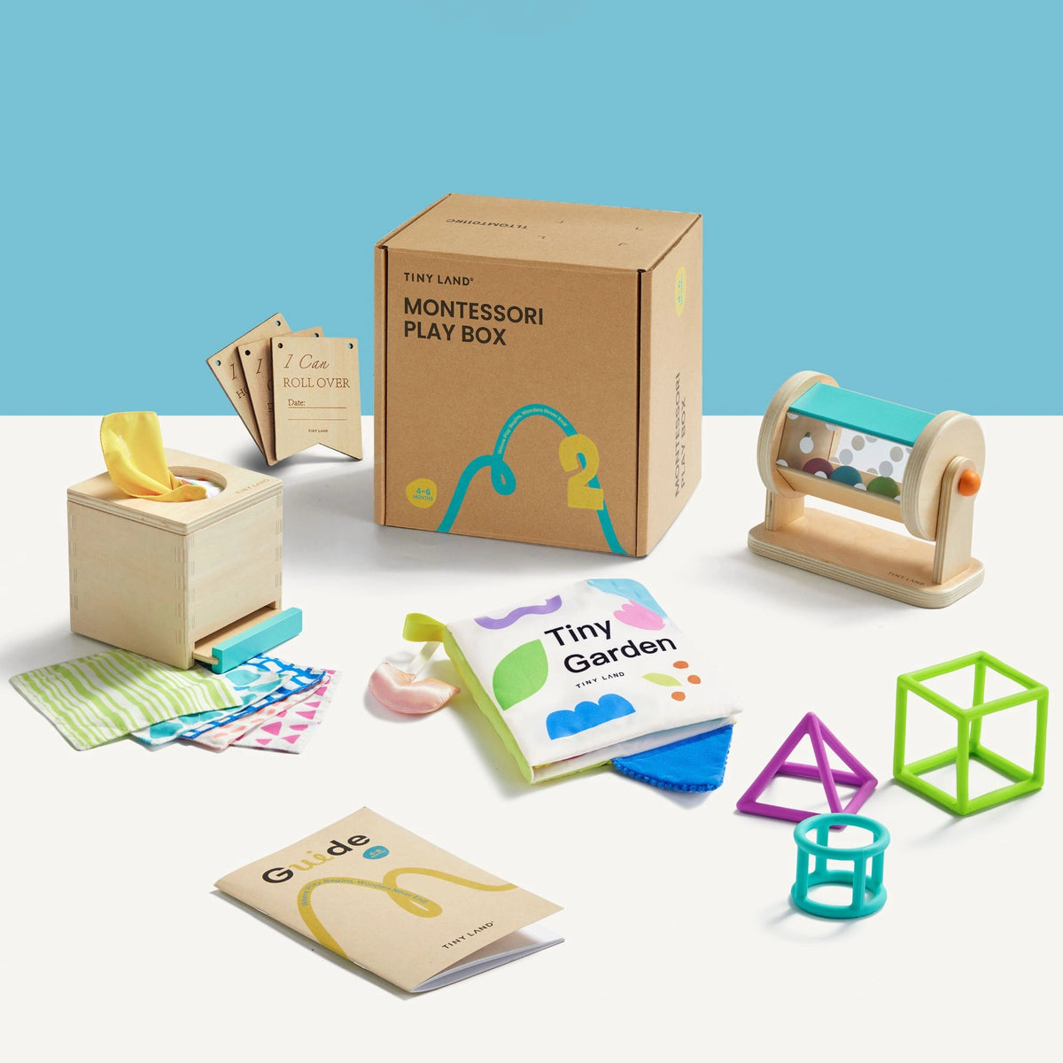 The Tiny Land® Montessori Toys for Newborns (4–6 Months) by Tiny Land includes a cardboard box, pull-out tissue box, soft scarves, sensory toys like a rolling rattle, guide booklet, fabric book, stacking toys, and colorful geometric shapes.