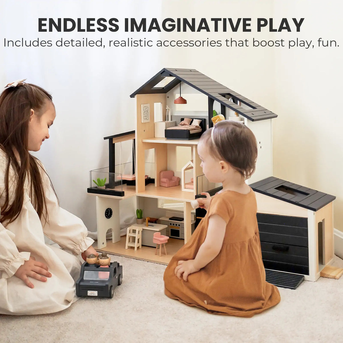 Two young children play with the Tiny Land® Sweetwood Edge Dollhouse & Wooden Dollhouse Garage, dressed in brown on a light carpet. They explore furnished mini accessories together. Text above: Endless Imaginative Play.