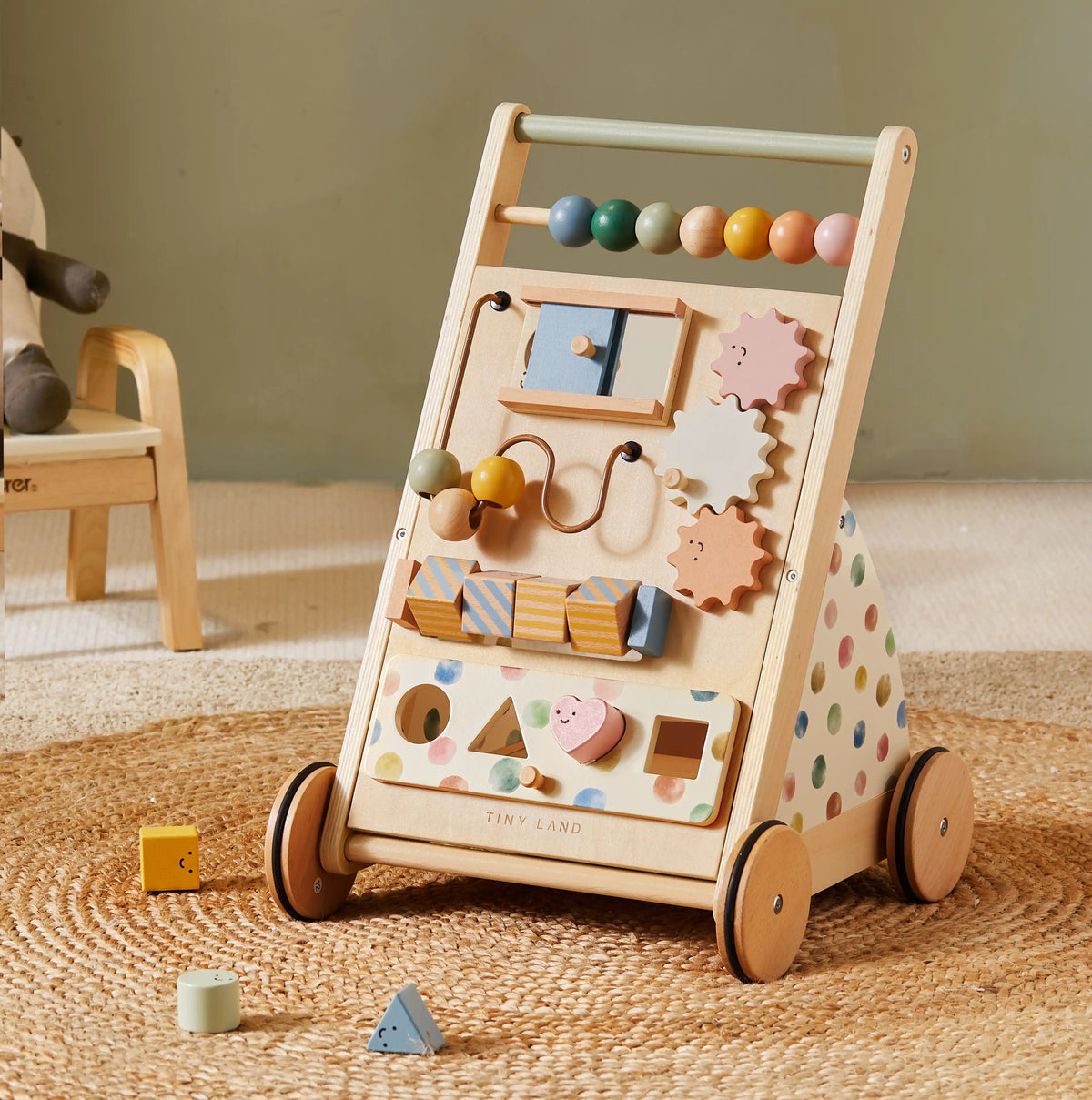 The Tiny Land® Versatile Natural Wooden Baby Walker features colorful beads, gears, shape blocks, wheels, pastel polka dots on the sides, and interactive elements—perfect for toddlers’ learning and play.